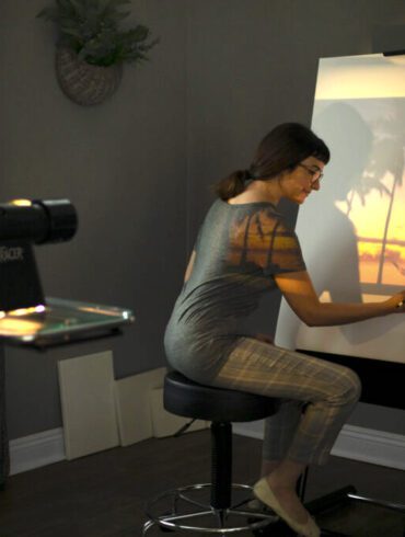 guide to using a project in your art. woman drawing with an artograph projector