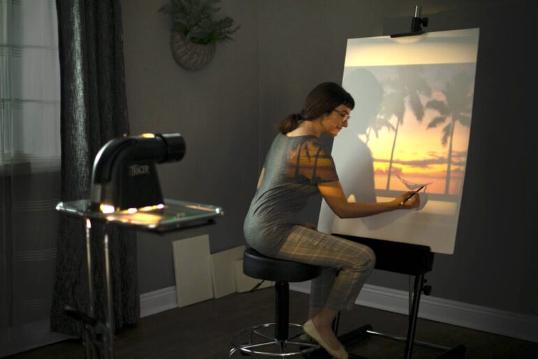 guide to using a project in your art. woman drawing with an artograph projector